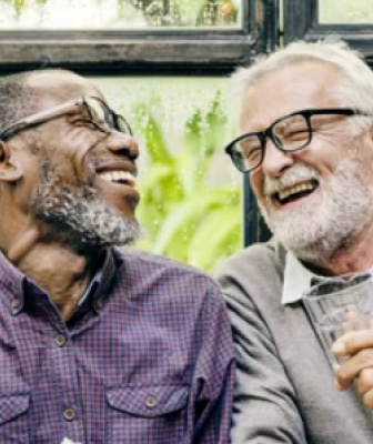 two elderly men laughing together